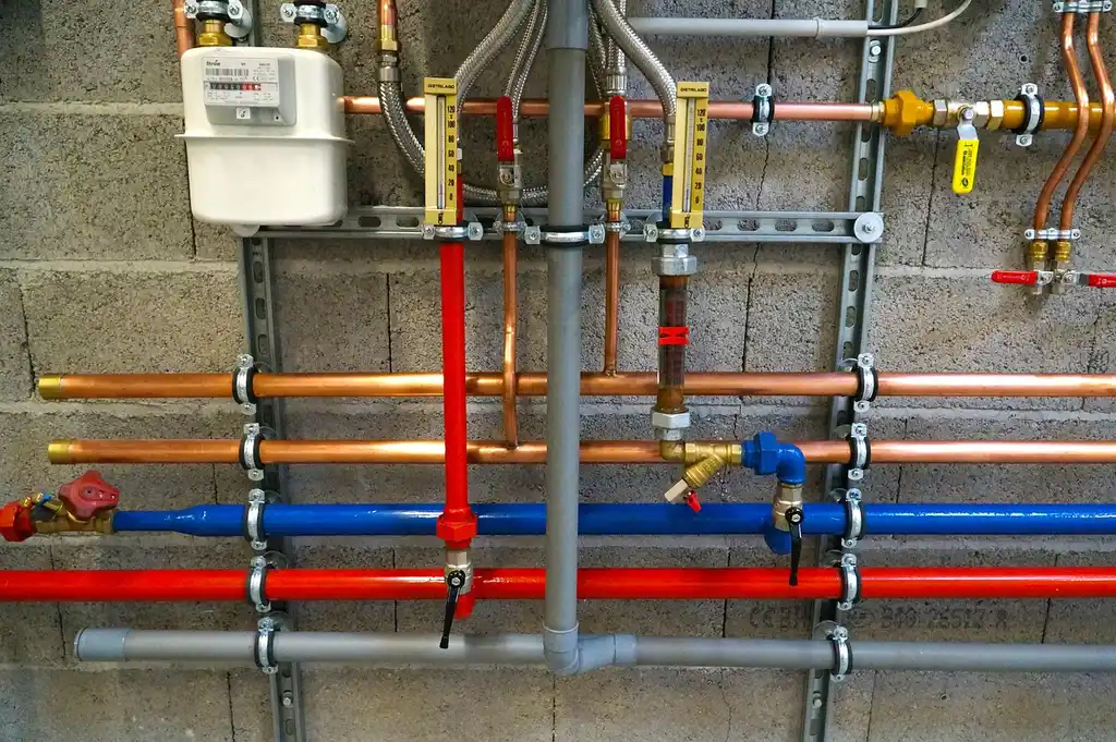 Plumber checks a newly installed water heater in a utility closet