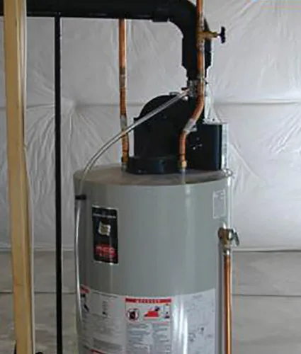 Close-up of a heater cord plugged into a GFCI outlet in an unfinished basement