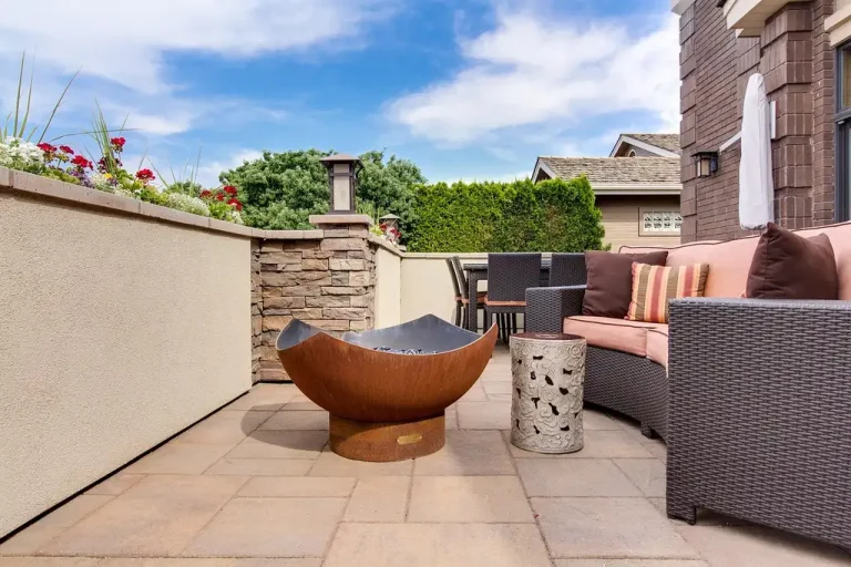 Homeowner compares an outdoor patio heater and an indoor space heater in separate spaces.