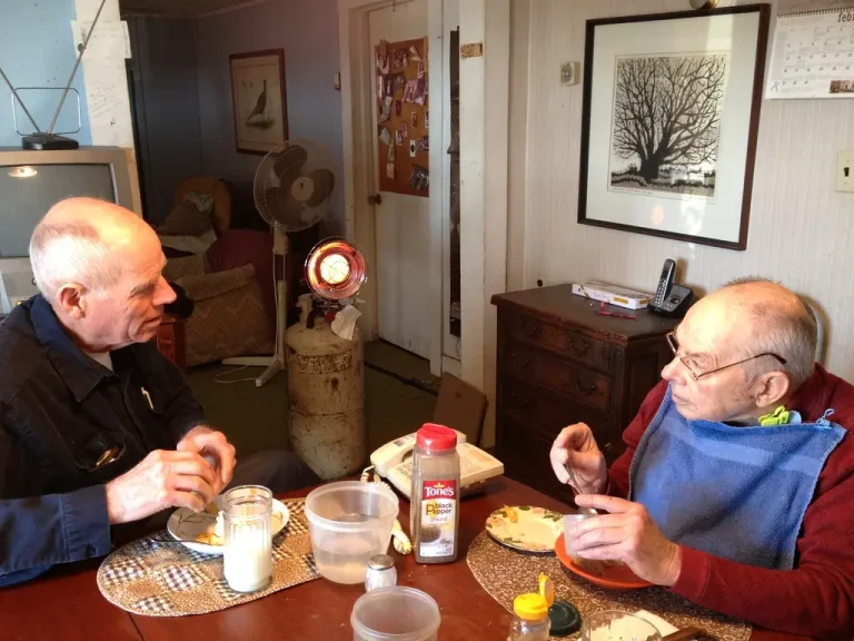 Portable heater types beside a person comparing costs in a winter living room