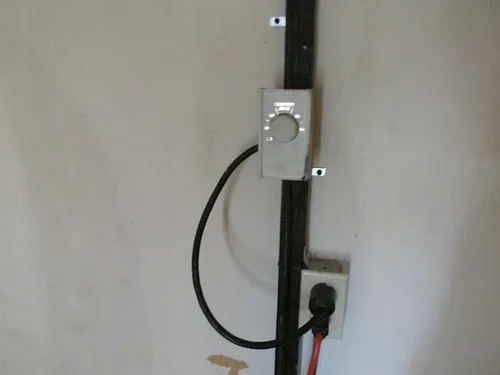 Portable heater plugged into a power meter for cost comparison